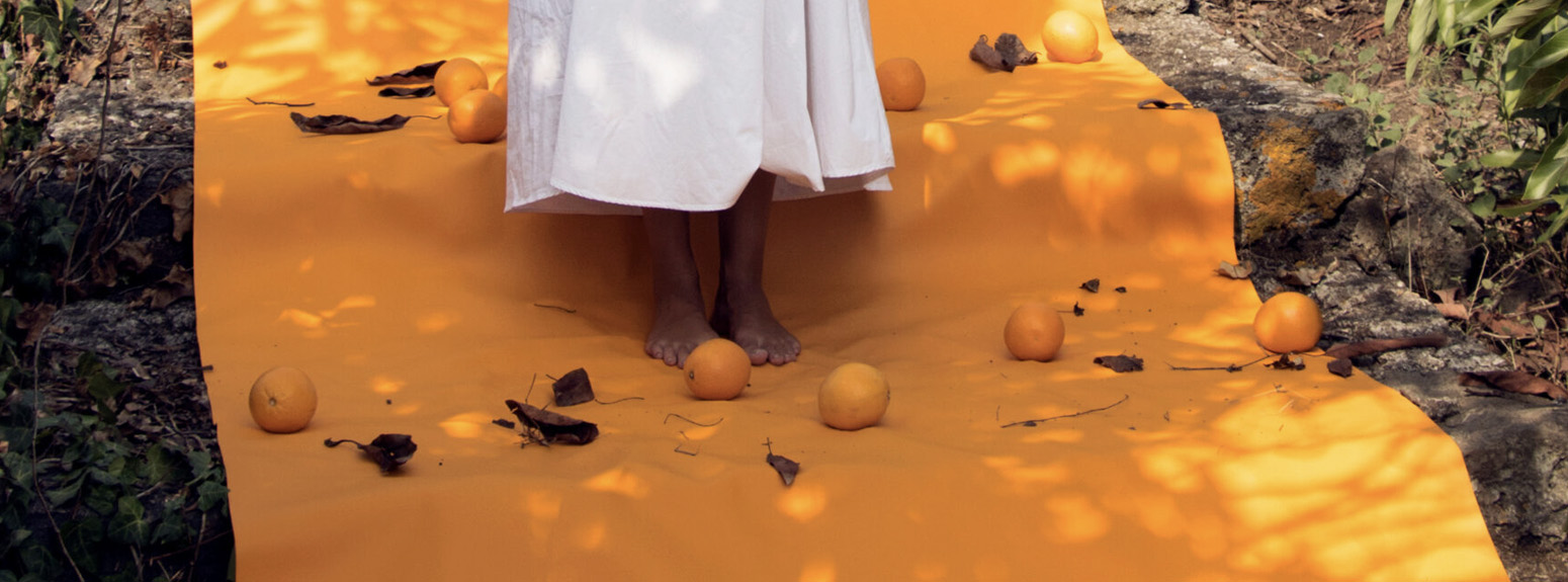  Woman walking on orange carpet with oranges 