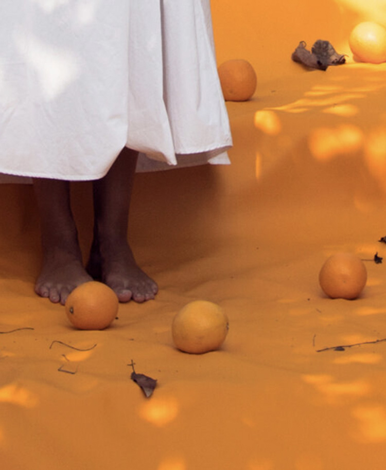  Woman walking on orange carpet with oranges 